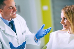 Dentist and patient discussing preliminary treatments before dental implants