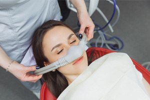 Female dental patient wearing nitrous oxide mask